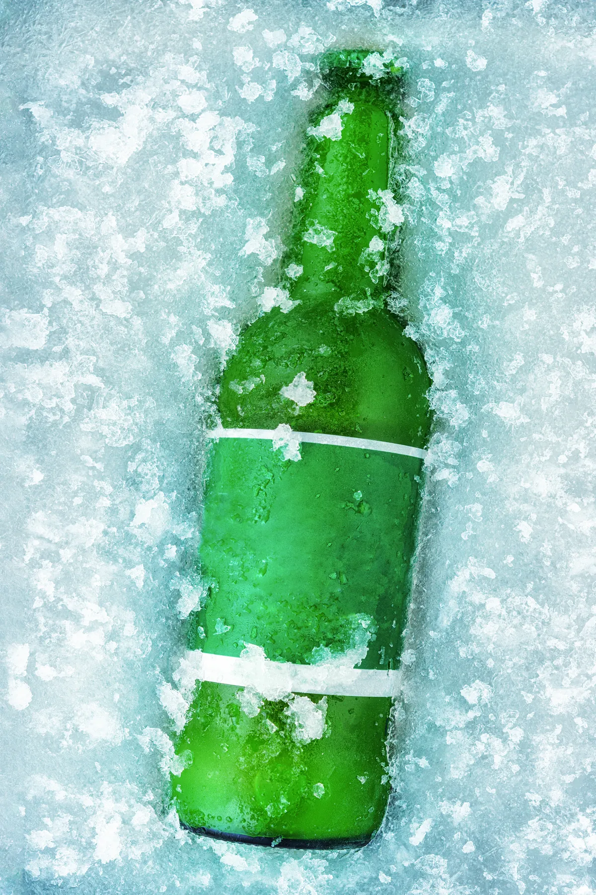 Ice-cold bottle of beer covered in frosty drops